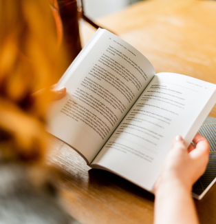 Person holding open book