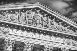 The front facade of the US Supreme Court building, carved in stone are the words "Equal Justice Under Law"