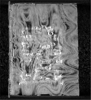 Scan of prayer book with unidentified metallic wire or thread visible in center of left side spine