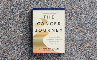 The book cover of The Cancer Journey, featuring an abstract pathway.