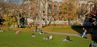 Campus Grounds with Students Sitting on Grass