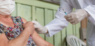 Health professional giving a shot to a patient in a third world country