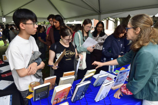 Hopkins students visit the Hopkins Press table at Democracy Day 2025